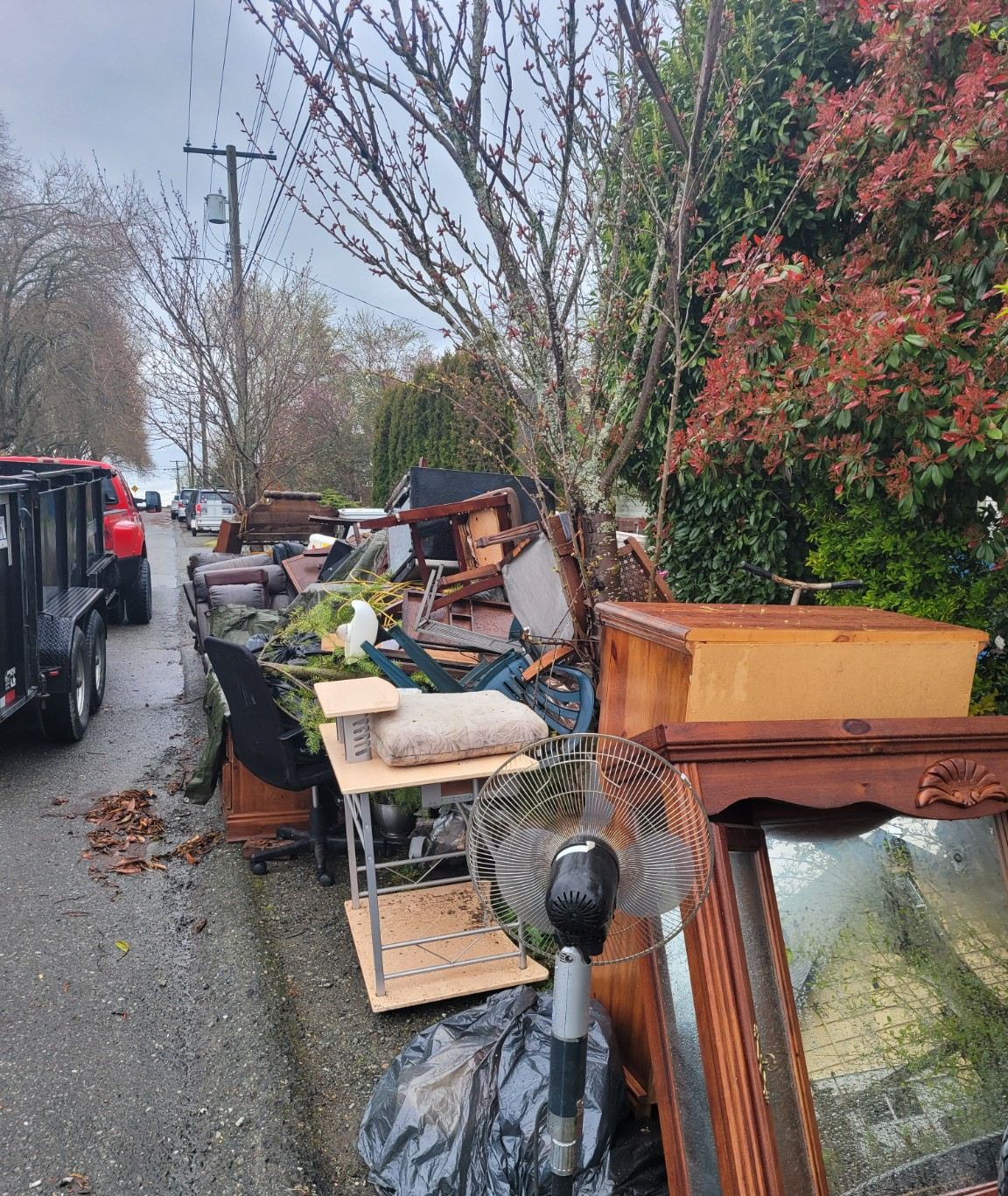 Mattresses and bedroom furniture piled curbside in Nanaimo before a Junk Matters pickup