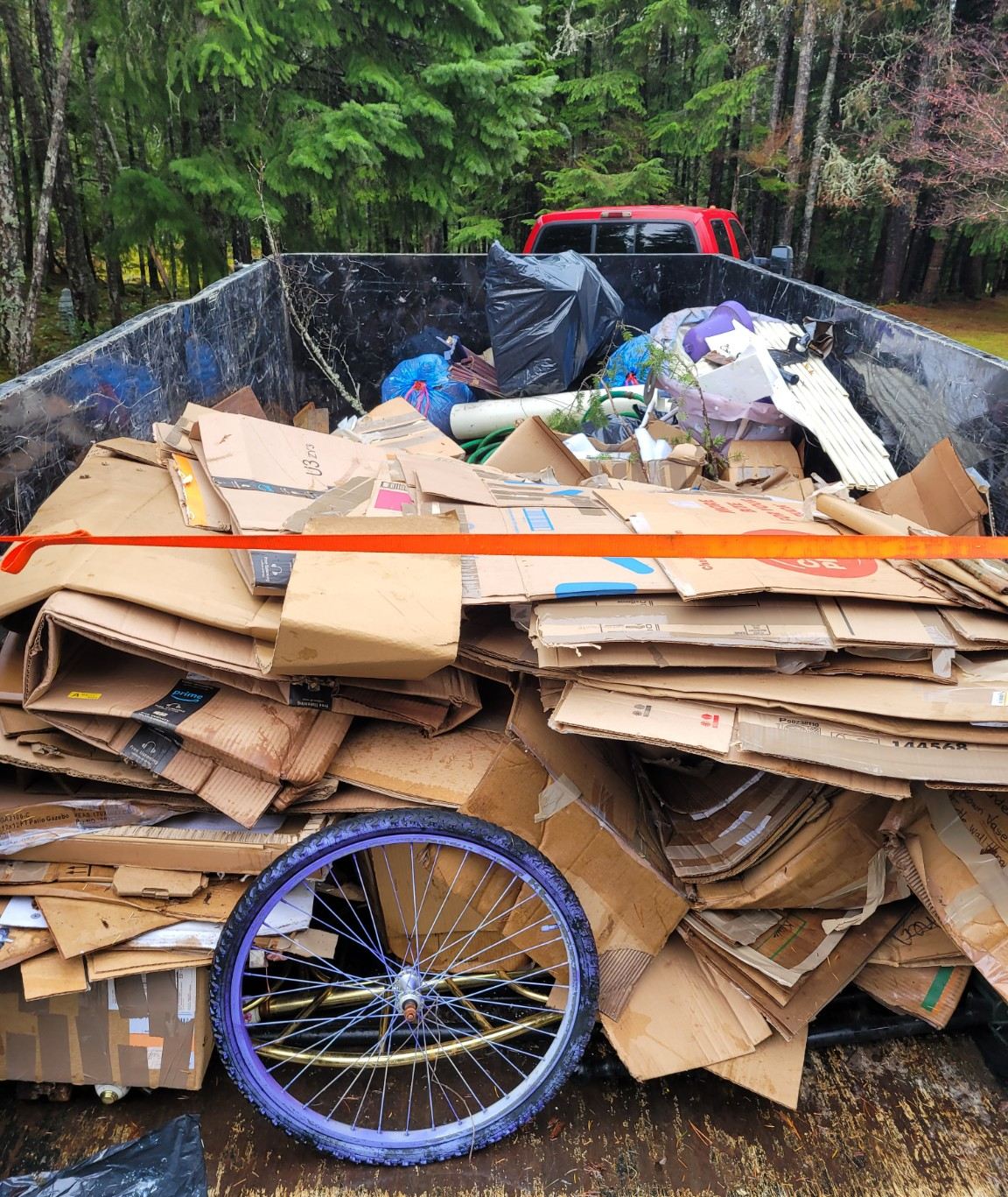 The Junk Matters trailer loaded with appliances and household junk in a Nanaimo driveway