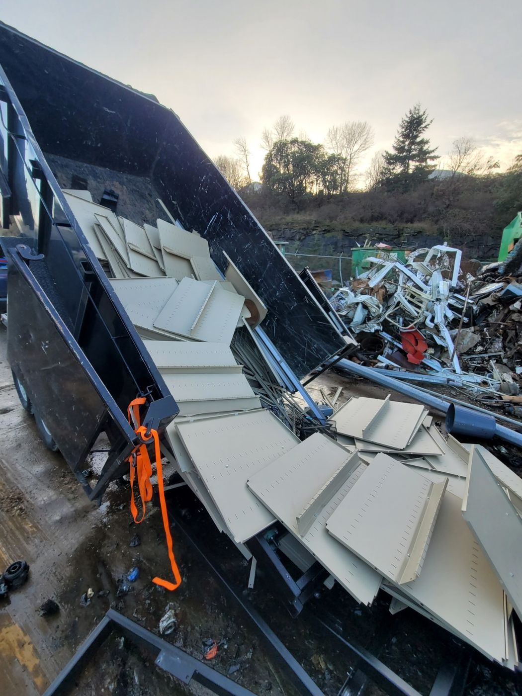 The Junk Matters dump trailer tipping a load of old siding and construction debris in Nanaimo