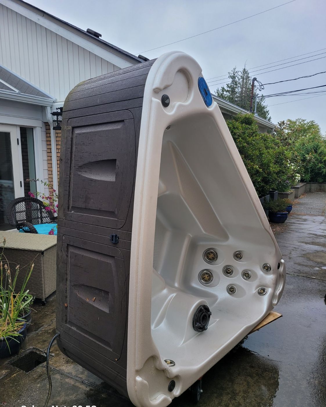 A hot tub stood on its end beside a Nanaimo house, waiting to be broken down for removal